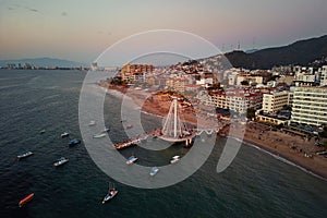 wide angle view of the Los Muertos Beach Pier looking towards Puerto Vallarta romantic zone in January