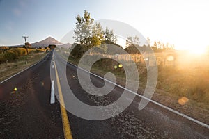 Wide angle view on Mount Taranaki Mount Egmont in New Zealand with road leading to it