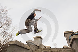 Wide angle view - parkour jumping in winter snow park - free-run training photo