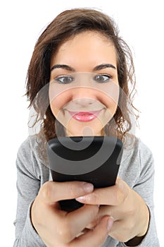Wide angle view of a pretty teenager girl happy with a smart phone