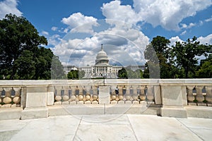 Wide angle view of the United States Capitol Building in Washington DC on a partly cloudy summer day