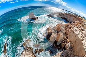 Wide angled shot of rocky coast near Agia Napa, Cyprus, with natural stone arch