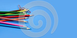 Wide banner template design concept, colorful pencils and clips on blue background