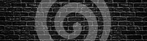 Wide black brick wall texture. Dark panoramic background