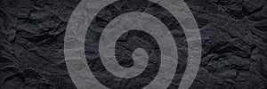 Wide black grunge banner. Dark gray stone background. Black rock texture.