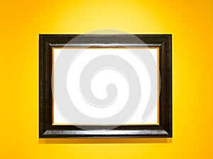 Wide black wooden picture frame on yellow wall