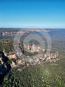 a wide blue mountain area with rocks and trees on either side