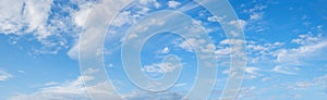 wide blue sky background with cirrus and fleecy clouds, panorama format