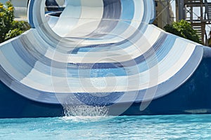Wide blue water slide in the water park.