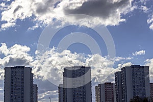 Wide clear shoot of array of concrete buildings with blue sky background