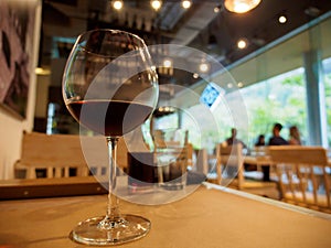 Wide close-up of red wine glass, Bangkok, Thailand