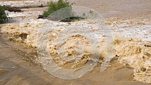 Wide dirty river with muddy water in flooding period during heavy rains in spring.