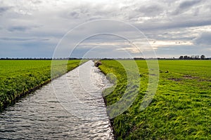 Wide ditch in a Dutch polder landscape