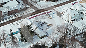 Wide drone view of a Naperville city covered with snow in winter time, american city with a private sector