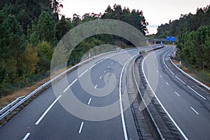 Wide empty highway with curve in the morning. Travel and destination background. Free asphalt road background.