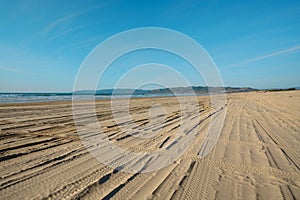 Wide empty sand beach and tire tracks on the sand. Oceano Dunes Vehicular Recreational Aria, California photo
