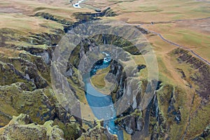 Wide estuary between hills in Iceland, winding blue river, stream. Tourist picturesque landscape.