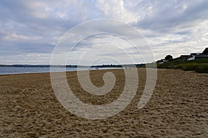 The wide expanse of Llanbedrog beach on a summer evening