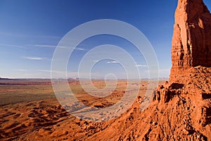 Wide expanses of Monument Valley with Spearhead Mesa on the right