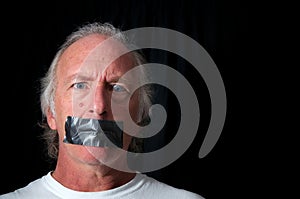 Wide eyed man with duct taped mouth