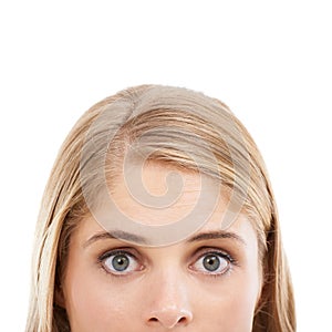 Wide-eyed wonder. Cropped studio shot of a young blonde woman isolated on white.