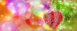 Wide festive banner. Red heart,Christmas decorations hanging on branch of Christmas Tree. Concept of New Year celebration. Copy