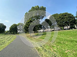 Wide footpath, with open grassland, and old trees near, Poplar Crescent, Shipley, UK