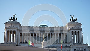 Wide front shot of National monument to Vittorio Emanuele II - Victor Emmanuel II at Piazza Venezia with Italian flags