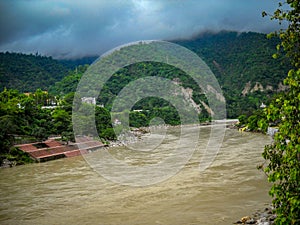 Wide Ganga river view with hills surround with clouds. Wide Ganga view in Rishikesh India photo