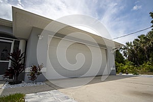 Wide garage double door and concrete driveway of new modern american house