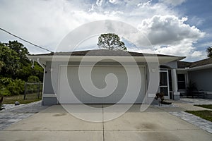 Wide garage double door and concrete driveway of new modern american house