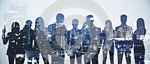 Wide image of business people silhouettes standing on abstract night city background. Teamwork and communication concept. Double