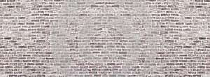 Wide red shabby brick wall texture. Old masonry panorama. Whitewashed rough brickwork panoramic vintage background