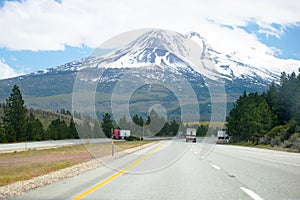 Wide multi - lines highway road with big rig semi trucks driving