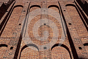 A wide old brick wall with recesses