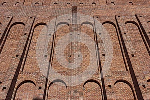 A wide old brick wall with recesses
