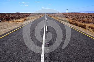 Wide open road in an arid landscape