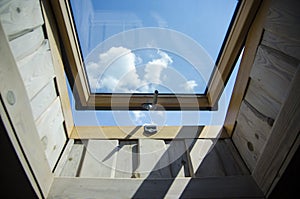 Wide open skylight window full frame looking out from inside seeing sky Isolated on dark background