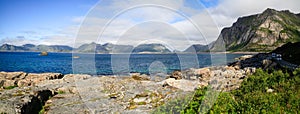 Wide panorama of the road and the mobile homes on the fjord coast Lofoten islands, Norway