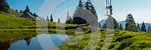 Wide panorama of typical wooden houses or cottages on the Velika planina or Mala Planina plateau in Slovenia on a hot sunny summer