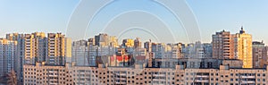 Wide panorama view of residential high-rise buildings, in the evening at sunset