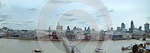 Wide panoramic aerial view of the city of london with historic landmarks and building in the business district with bridge