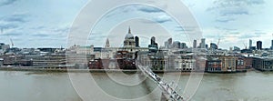 Wide panoramic aerial view of the city of london with historic landmarks and building in the business district with pedestrian bri