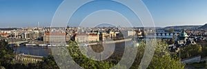 Wide panoramic aerial view of Prague Old Town architecture roof top and Charles Bridge over Vltava river seen from Letna