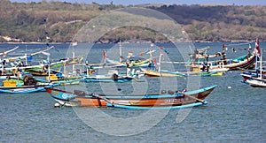 Beautiful picture of fishing boats at Jimbaran Bay at Bali Indonesia, beach, ocean, fishing boats and airport in photo.