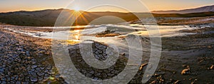 Wide panoramic view of Mud volcanoes with stunning sunrise in Chahuna managed reserve in Georgia