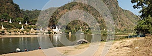 wide panoramic view of a river on the border between Thailand and Myanmar with white stupas and pagodas