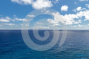 Wide, peaceful, blue ocean landscape under a sunny blue sky with white clouds, Oahu, Hawaii, USA