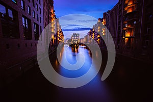 Wide perspective of Warehouse District - Speicherstadt in twilight. Tourism landmark of Hamburg. View of Wandrahmsfleet