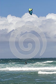 A wide power kite is used to drive the rider over the water during kiteboarding or kitesurfing.